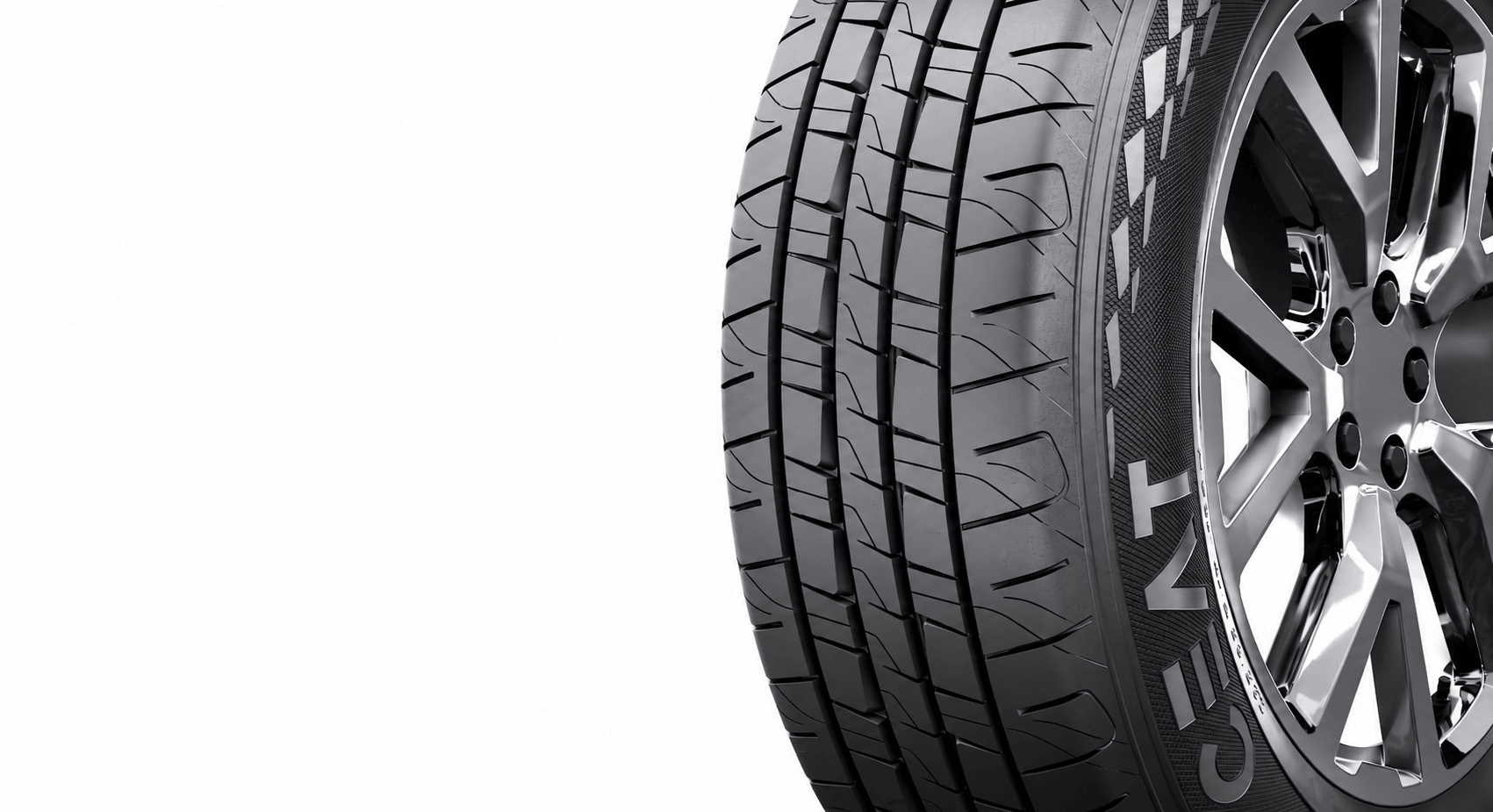 Close-up of a CEAT tyre on a chrome wheel, its tread and moulded sidewall lettering